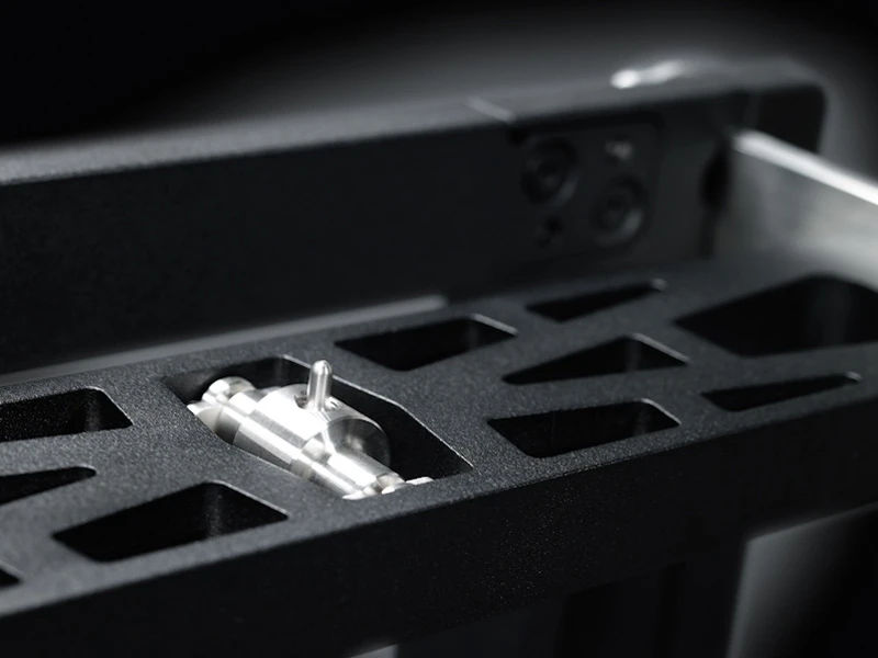 Close-up of the silver rocker support mechanism integrated into KEO’s perforated beam