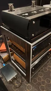 Detail of the new ITO rack's wood-finished side panel and metal frame beneath the audio equipment.